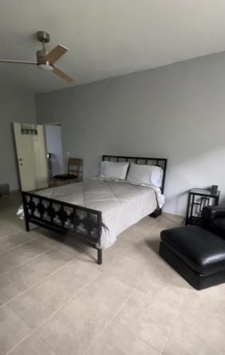 a bedroom with a bed and a chair at Villa Vicente Casa Soares in Vila Nova Sintra