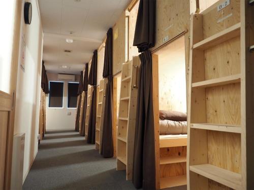 a hallway filled with wooden doors and shelves at Choine Hotel Sapporo Teine - Vacation STAY 97420v in Sapporo