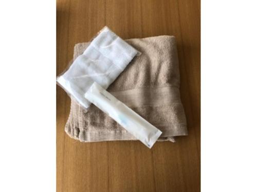 a towel sitting on top of a wooden table at Choine Hotel Sapporo Teine - Vacation STAY 97420v in Sapporo