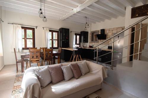 a living room with a couch and a dining room at Kavos House in Meyisti