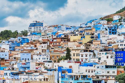 a group of blue and white houses on a hill at TAJ CHEFCHAOUEN Luxury Hotel and Spa in Chefchaouen