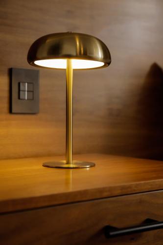 a brass lamp sitting on top of a desk at Punta Alameda in Mexico City
