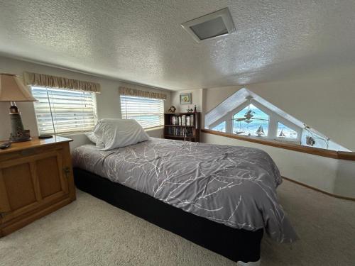 a bedroom with a bed and a window at Oceanfront Cabin 9 With Jacuzzi & Awesome Views in Smith River