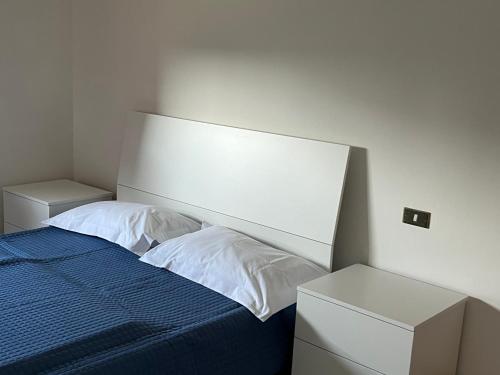 a bedroom with a bed and two night stands at Casa Ivana in Castiglione del Lago