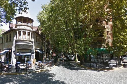 a street with a building with a tower on it at Beautiful apartment in the heart of Vicente López in Olivos