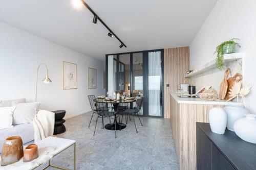 a living room with a couch and a table at Wonderful architect designed flat with sea view in Ostend