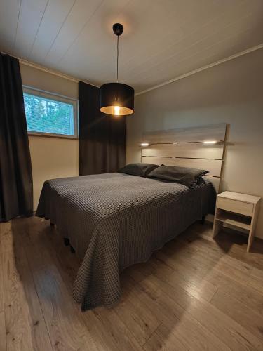 a bedroom with a large bed and a window at Arctic Hill Apartment in Rovaniemi