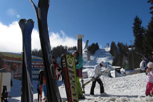 a group of people standing in the snow with skis at Apartmán Štrbské Pleso - Crocus 219 in Štrbské Pleso