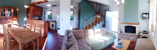 a living room with a couch and a fireplace at Maison Viros in Kardamyli