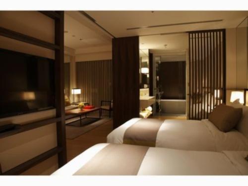 a hotel room with a bed and a bathroom at Olive Bay Hotel - Vacation STAY 91402v in Saikai