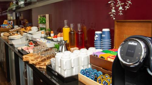a buffet line with food and drinks and a watch at Crowne Plaza Birmingham City by IHG in Birmingham