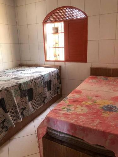 Ένα ή περισσότερα κρεβάτια σε δωμάτιο στο Casa beiramar sitio do conde