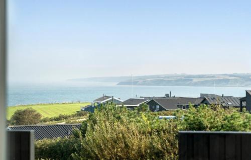 a row of houses with the ocean in the background at Cozy Home In Lemvig With Wifi in Lemvig
