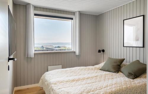 a bedroom with a bed and a window at Cozy Home In Lemvig With Wifi in Lemvig