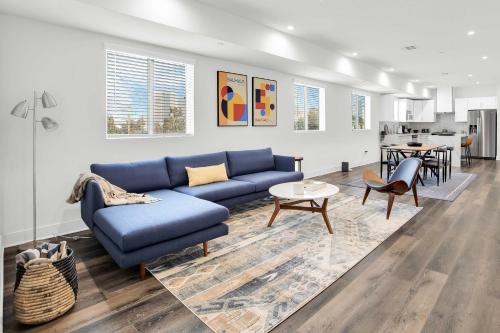 a living room with a blue couch and a table at Spectacular Rooftop View House in Los Angeles