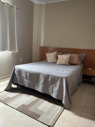 a bedroom with a bed with pillows on it at Rosendo Maia n 19 Bairro Brasiliana in Arapiraca