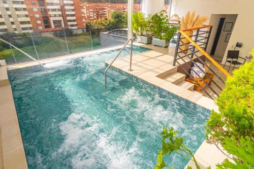 a swimming pool on the roof of a building at Biohotel Organic Suites in Bogotá