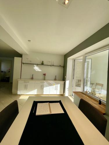 a dining room with a table and a large window at Harmony Home in Stavanger