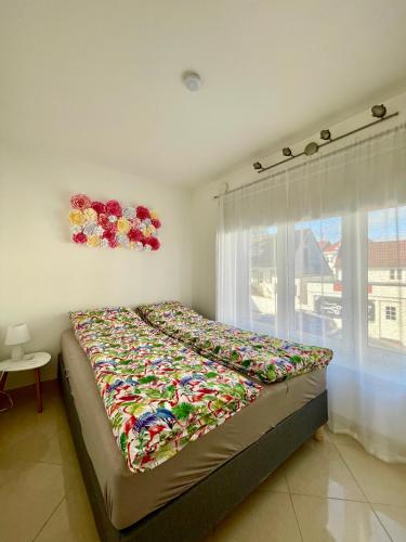 a large bed in a bedroom with a window at Harmony Home in Stavanger
