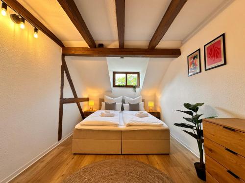 a bedroom with a large bed in a attic at YourFavoriteBed Designerapartments Zwickau Zentrum in Zwickau
