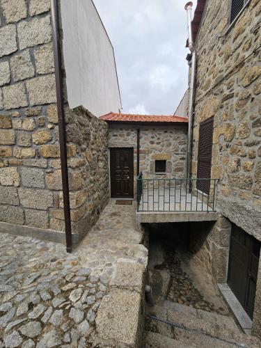 an alleyway in an old stone building with a door at Casa Velha in Linhares