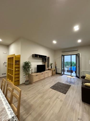 a large living room with a couch and a television at Paradise House in Luco dei Marsi