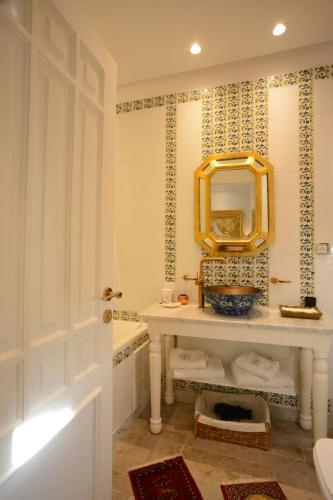 a bathroom with a sink and a mirror at Dar Essalem in Sidi Bou Saïd