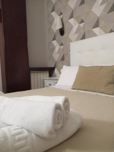 a hotel room with a bed with a towel on it at Hotel Sanchez in Aínsa