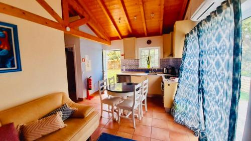 a kitchen with a couch and a table in a room at Mountain View 2 Bedroom Chalet in Alcobaça
