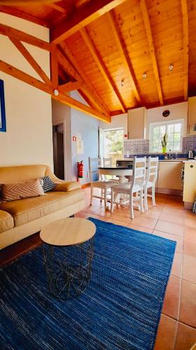 a living room with a couch and a table at Mountain View 2 Bedroom Chalet in Alcobaça
