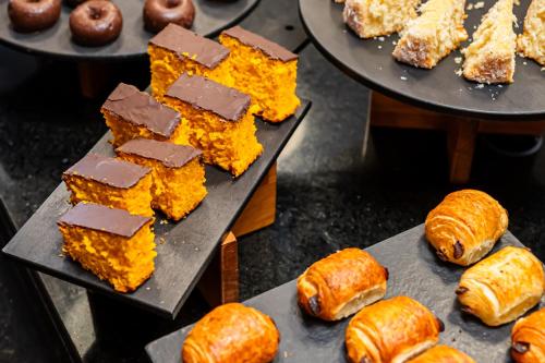 a bunch of different types of pastries on plates at ibis Santo Andre in Santo André