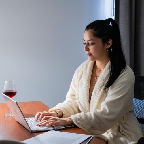 a woman sitting at a table using a laptop computer at La Quinta by Wyndham Reynosa in Reynosa