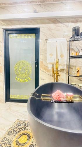 a bath tub in a bathroom with a sign at House of Versace in Gqeberha