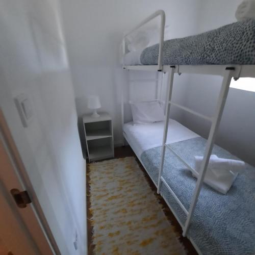 a small room with a bunk bed and a rug at Casa da Soma in Viseu