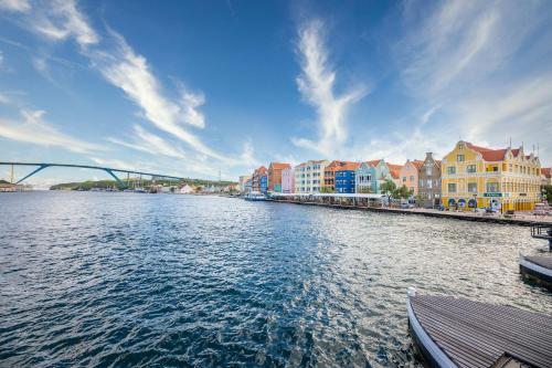 a view of a river with buildings and a bridge at Seabreeze Retreat Stylish Blue Bay Residence in Sint Michiel