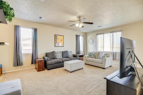 a living room with couches and a flat screen tv at Family-Friendly Home with Mtn View in Albuquerque! in Albuquerque