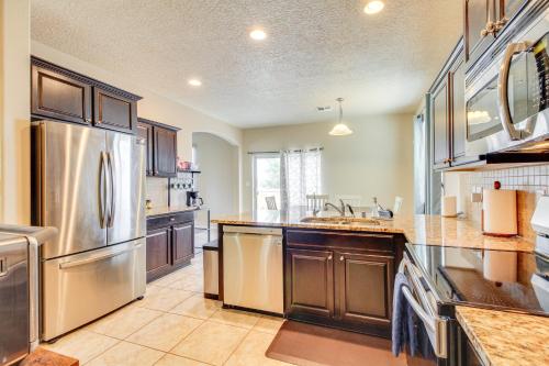 a large kitchen with a stainless steel refrigerator at Family-Friendly Home with Mtn View in Albuquerque! in Albuquerque