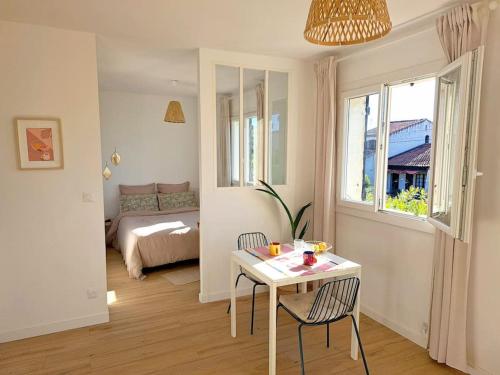 une pièce avec une table et des chaises et une chambre dans l'établissement Lou Pitchou, le T1, à La Ciotat