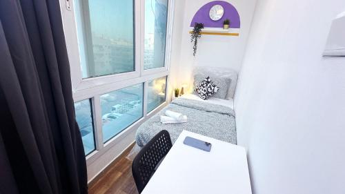 a small room with a couch and a large window at Partition Room In Al Seef Near Burjuman Metro in Dubai