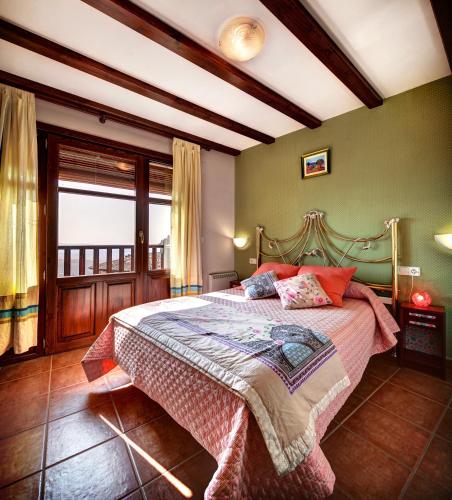 a bedroom with a large bed in a room at Apartamentos Bellavista in Alquézar