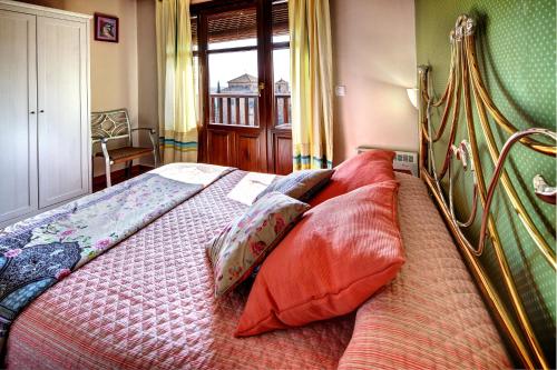 a bedroom with a bed with pillows on it at Apartamentos Bellavista in Alquézar
