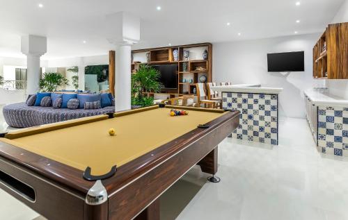 a living room with a pool table and a couch at Mar del Cabo By Velas Resorts Adults Only in San José del Cabo