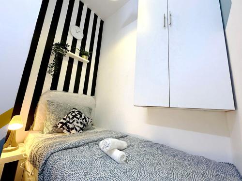 a bedroom with a bed and a white cabinet at Cozy Corner Partition Room Near Burjuman Metro in Dubai