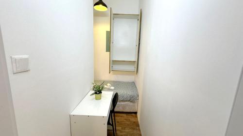 a small room with a bed and a mirror at Cozy Corner Partition Room Near Burjuman Metro in Dubai