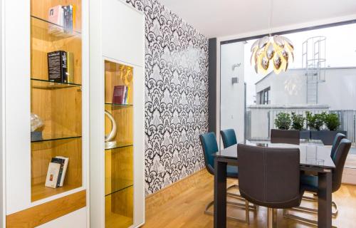 a dining room with a table and chairs at VotivPark Vienna Serviced Apartments in Vienna