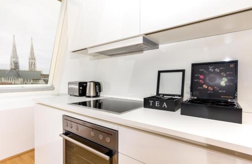 a kitchen with a laptop computer on a counter at VotivPark Vienna Serviced Apartments in Vienna