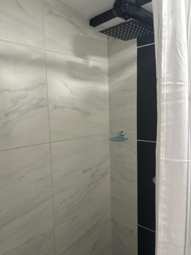 a shower with a black tie in a bathroom at hosteline in Villa de Leyva