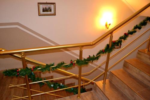 a stair railing with christmas garland on it at Zlata Praha in Mukacheve