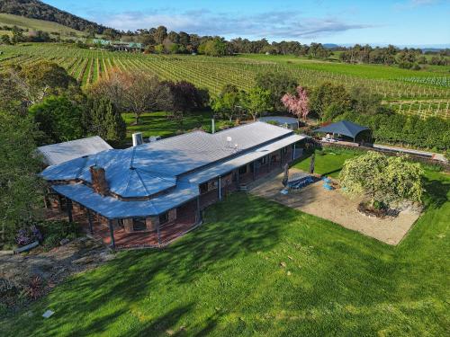 an overhead view of a house with a blue roof at Yarra Yering Homestead in Gruyere