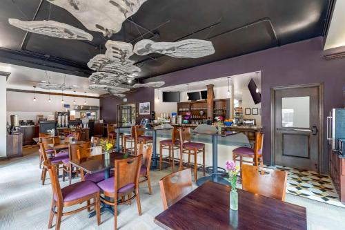 a dining room with tables and purple chairs at Best Western Denver Southwest in Lakewood